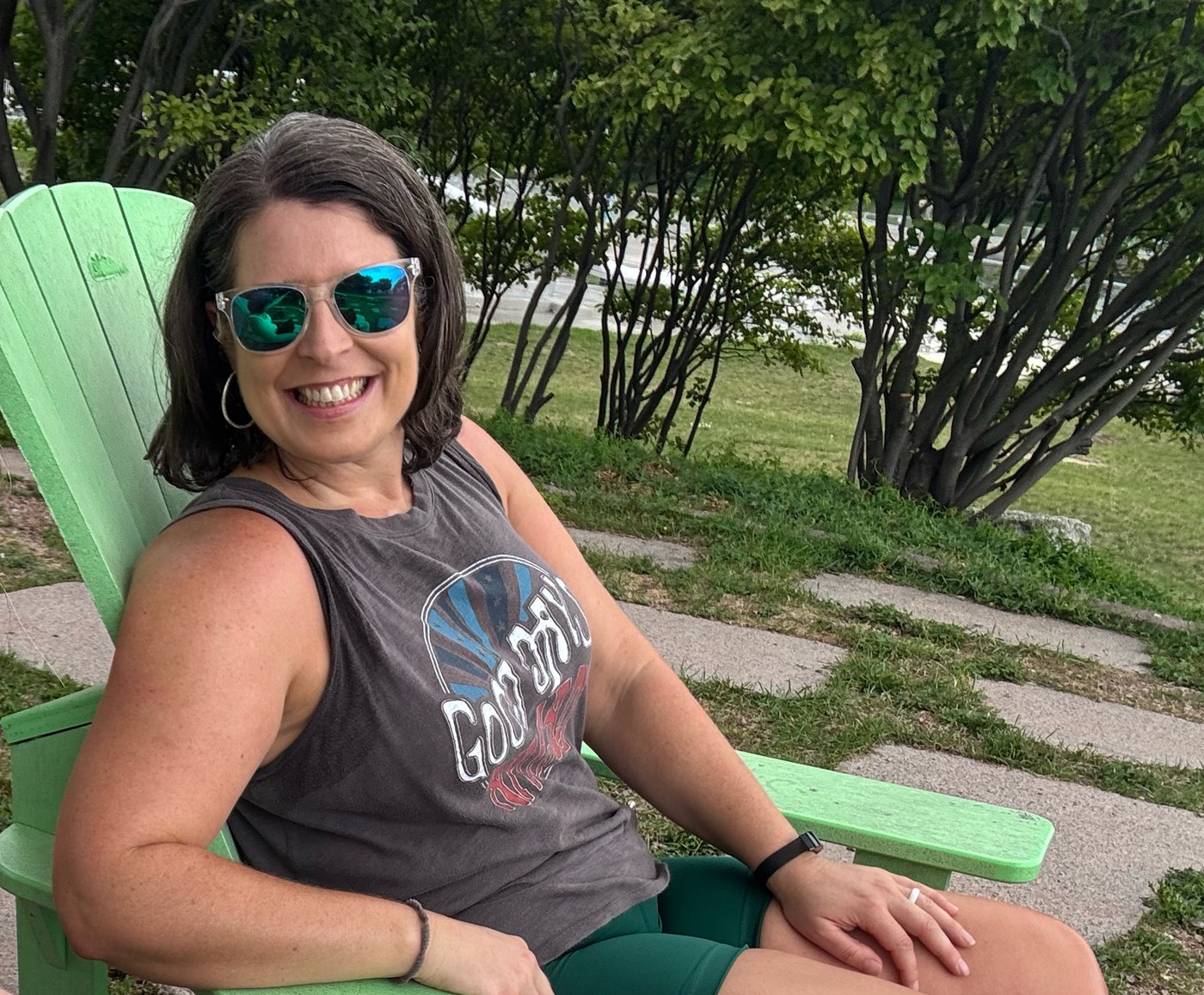 A. Sebesta seated outdoors in a green chair